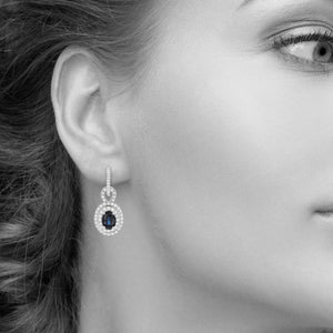 Oval Blue Sapphire and Diamond Double Halo Drop Earrings in 18kt White Gold