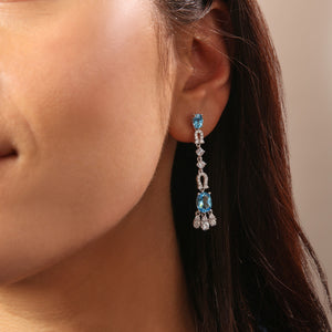 Oval Blue Topaz, White Sapphire, and Diamond Dangle Earrings in 14kt White Gold